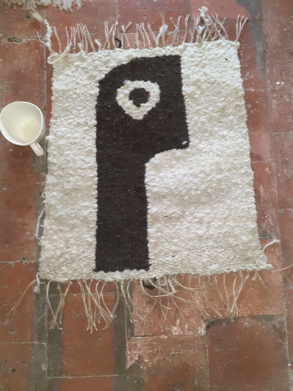 Cream and brown handwoven geometric rug with fringe